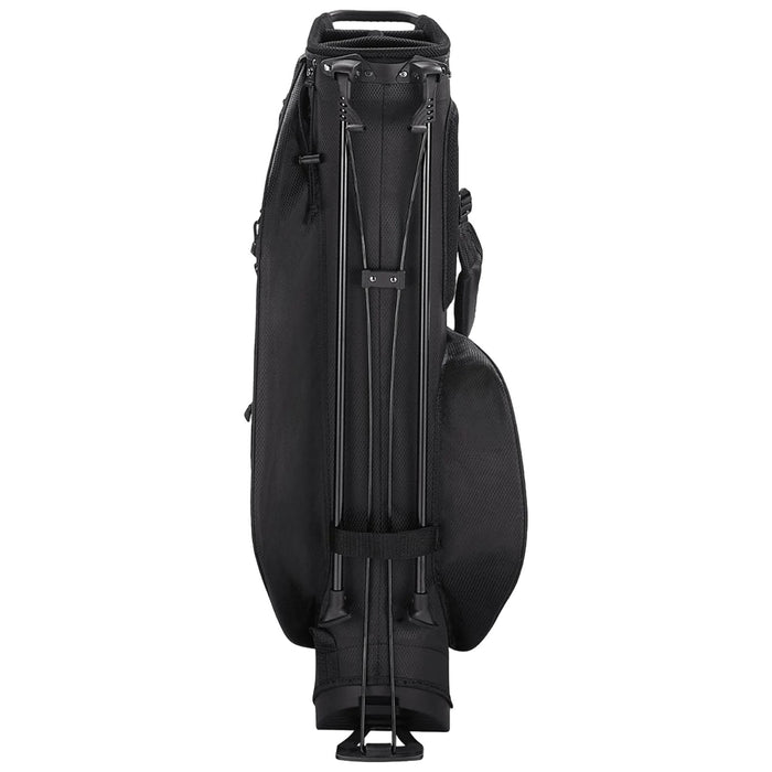 A black golf travel bag stands upright with telescopic handles extended providing a means to roll it. The bag is designed for transportation of golf clubs and equipment.