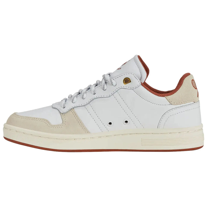A white sneaker with beige accents is displayed while facing left showcasing its laces and cushioned collar set against a plain background emphasizing the shoe's sleek design and colors