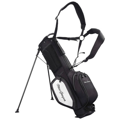 A black and white golf bag stands upright with extending legs and shoulder straps designed for carrying. It features multiple zippered pockets and a prominent brand name on the side.