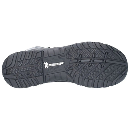 A black rubber shoe sole displays a textured tread pattern with a prominent logo and the words slip and oil resistant indicating its design for safety and traction in various environments.