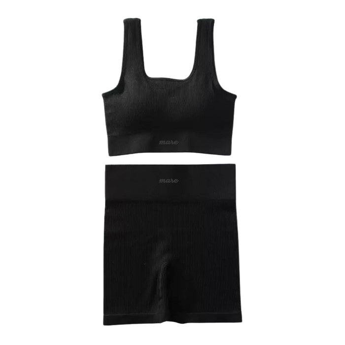 Black ribbed tank top and shorts set on a white background