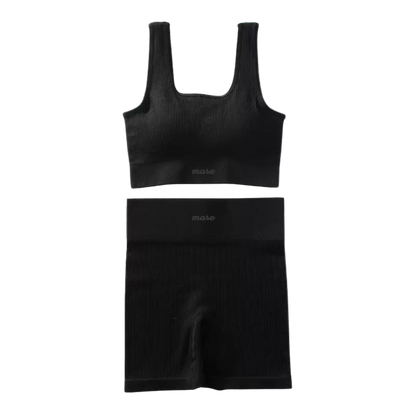 Black ribbed tank top and shorts set on a white background