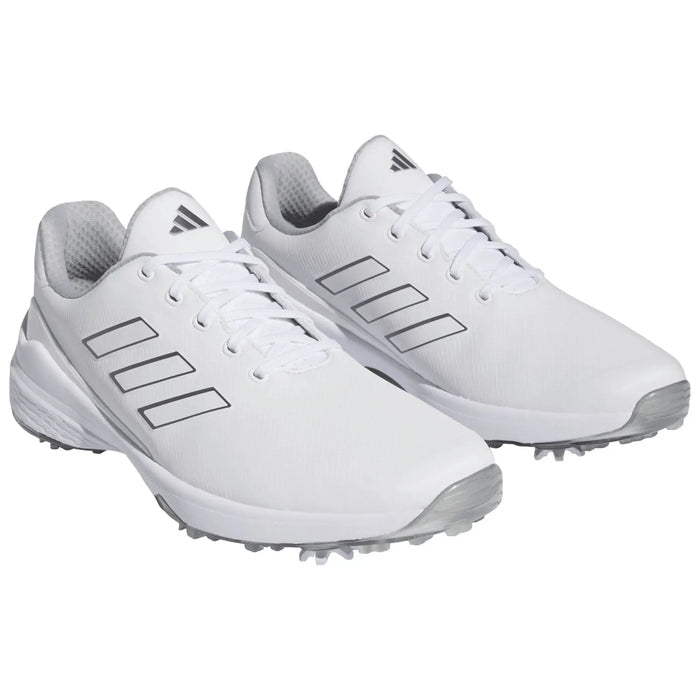 White athletic shoes are positioned side by side showcasing their sleek design and contrasting grey accents made for sports use in various outdoor environments