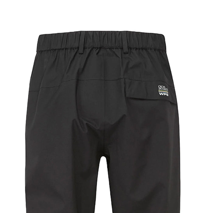 Black waterproof pants hang vertically showcasing their elastic waistband and a rear pocket with branding near the top edge in a simple undisturbed setting