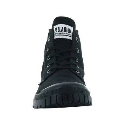 Black high-top shoe stands upright displaying a lace-up front and rubber sole in a simple, uncluttered setting emphasizing its design and branding with label visible on the tongue
