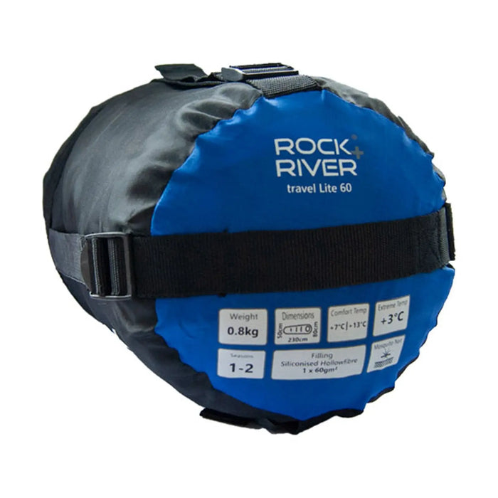 A round black and blue travel sleeping bag is displayed resting on a flat surface featuring a strap for securing it the labeled area indicates its weight dimensions and temperature ratings.